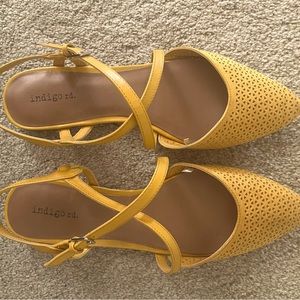 Yellow closed-toe open heel with adjustable staps.